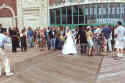 Beautiful bride mysteriously appears by Convention Hall. 